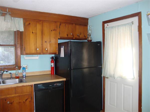 118 High Street Rochester, MA 02770 - Photo 3 of 13 a kitchen with a refrigerator and a sink
