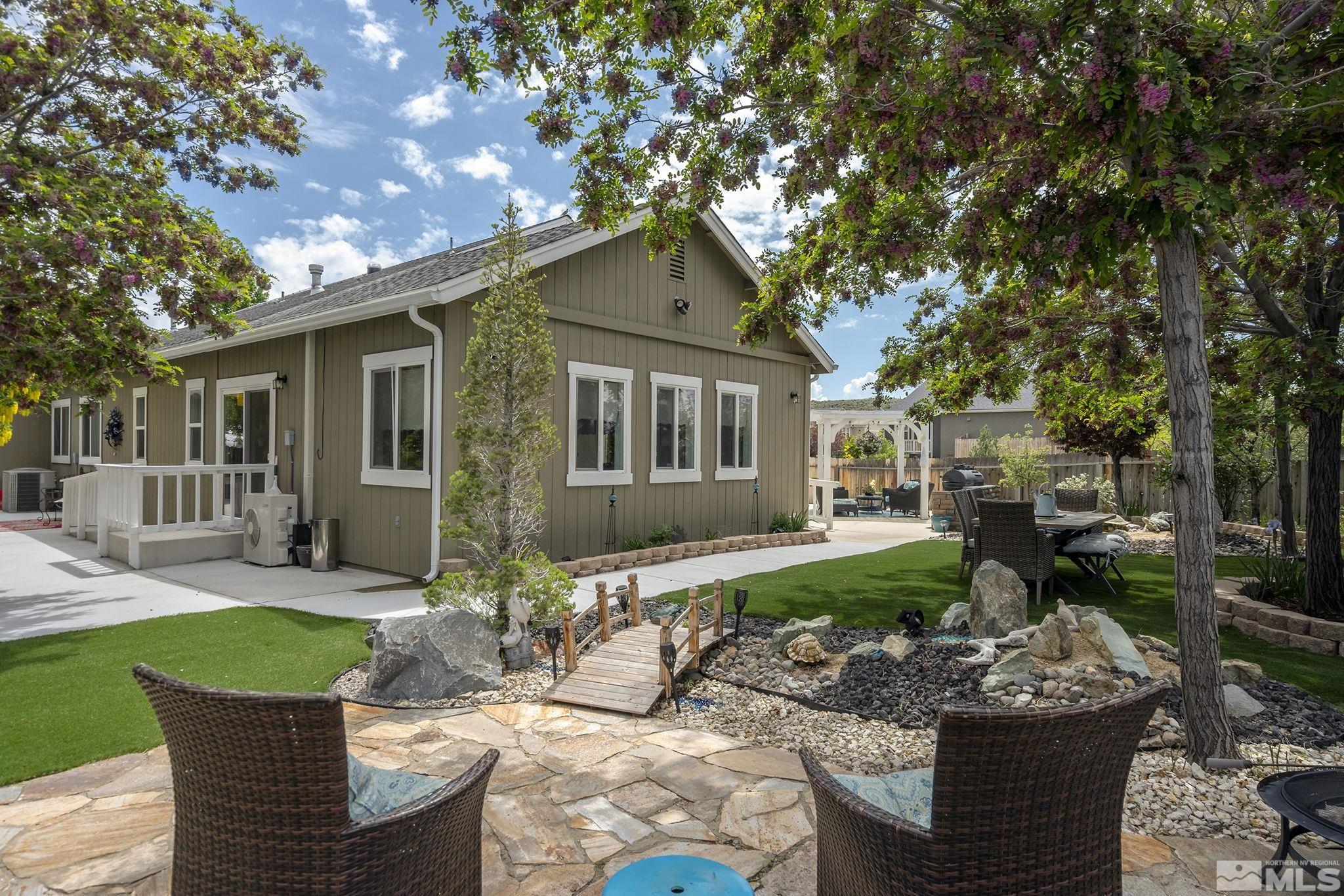 7615 Crest Bluff Drive Reno, NV 89506 - Photo 31 of 32 a view of a house with backyard sitting area and garden