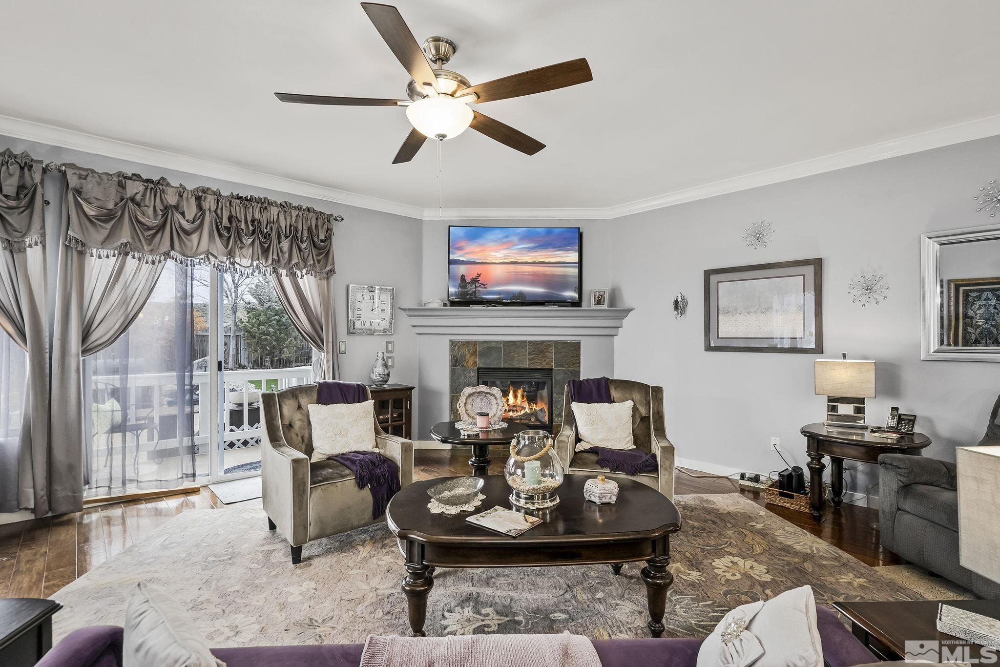 7615 Crest Bluff Drive Reno, NV 89506 - Photo 5 of 32 a living room with furniture a fireplace and a large window