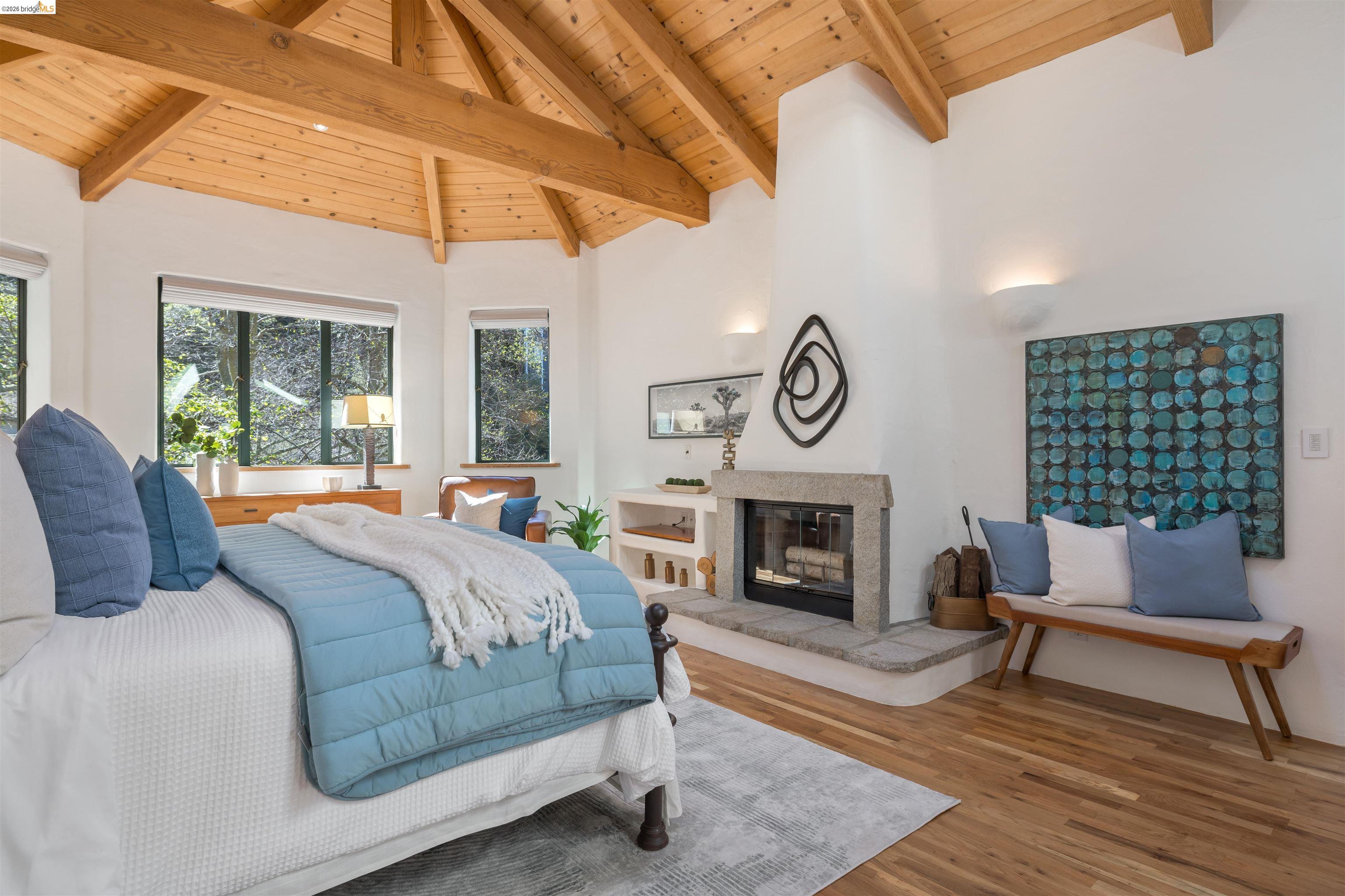 1102 Grand View Drive Berkeley, CA 94705 - Photo 27 of 50 a bedroom with a bed and a fireplace