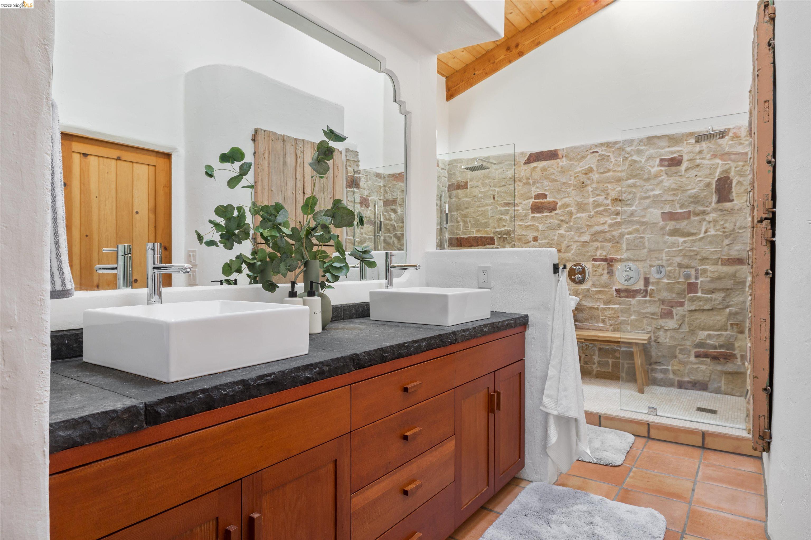 1102 Grand View Drive Berkeley, CA 94705 - Photo 30 of 50 a bathroom with a granite countertop sink a toilet and shower