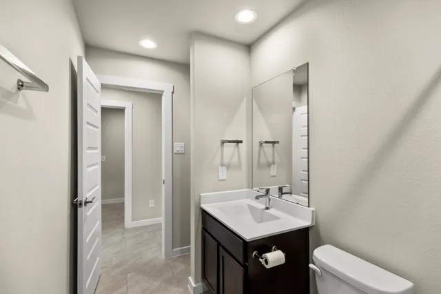 a bathroom with a sink a toilet and a mirror