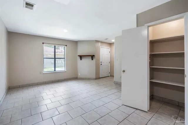 a view of a livingroom with wooden floor and a bathroom