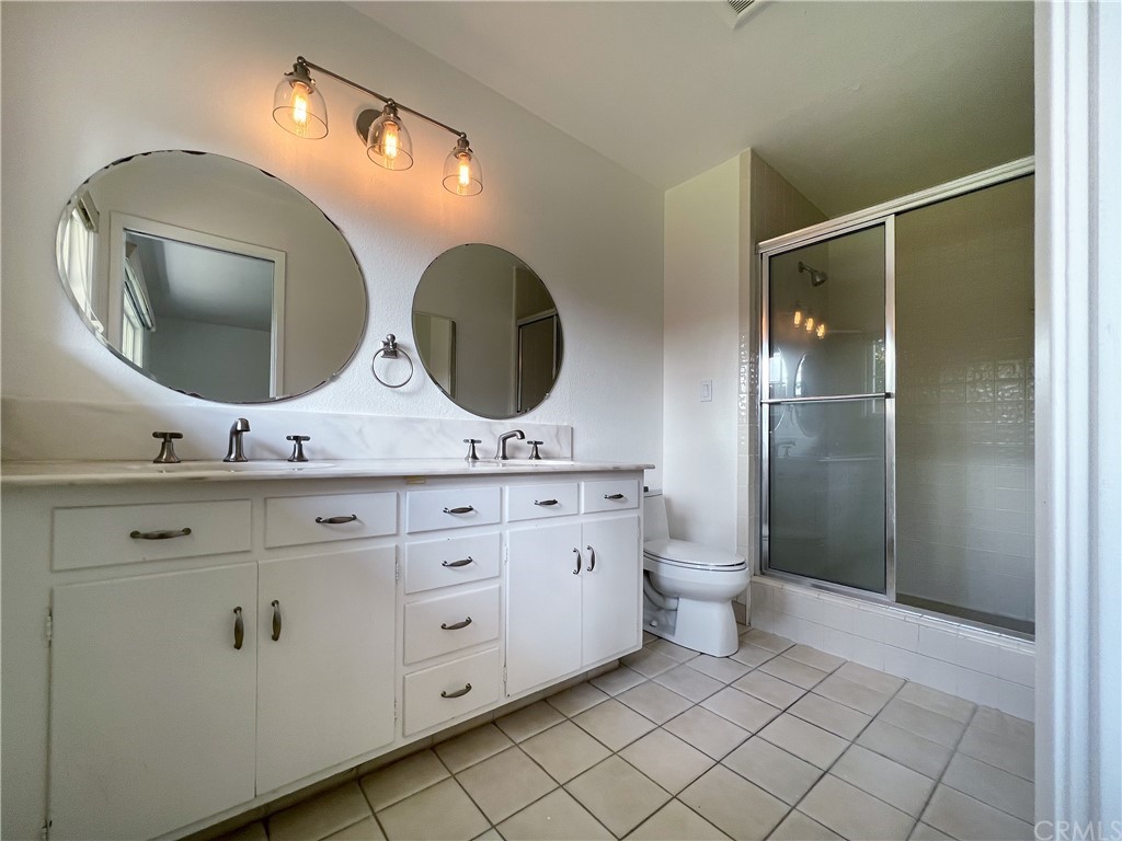1921 Mariners Drive Newport Beach, CA 92660 - Photo 14 of 17 a bathroom with a double vanity sink and a mirror