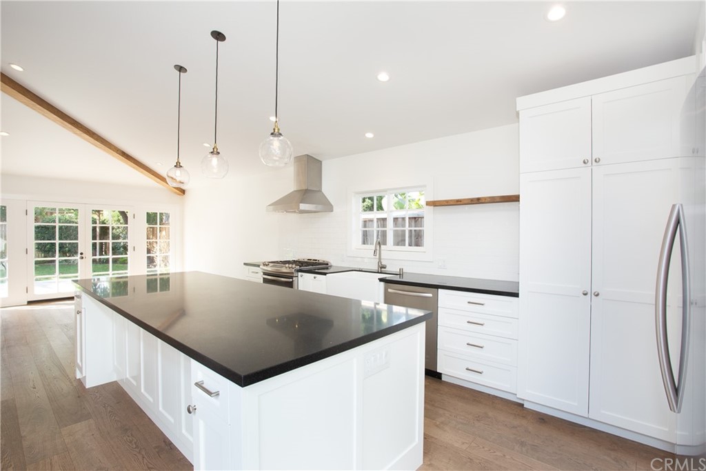 1921 Mariners Drive Newport Beach, CA 92660 - Photo 4 of 17 a kitchen with stainless steel appliances granite countertop a sink a stove and a refrigerator