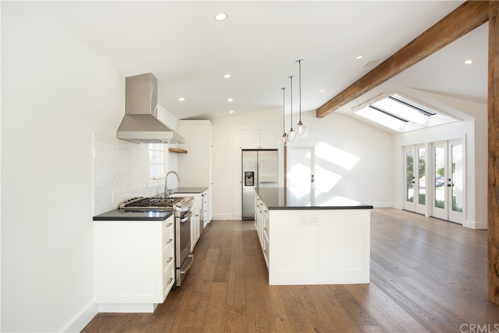 1921 Mariners Drive Newport Beach, CA 92660 - Photo 6 of 17 a view of a kitchen with wooden floor and stainless steel appliances