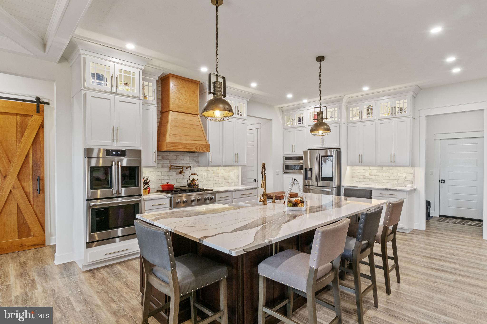 4073 Landis Road Hanover, PA 17331 - Photo 18 of 100 a kitchen with granite countertop a table chairs stainless steel appliances and wooden floor