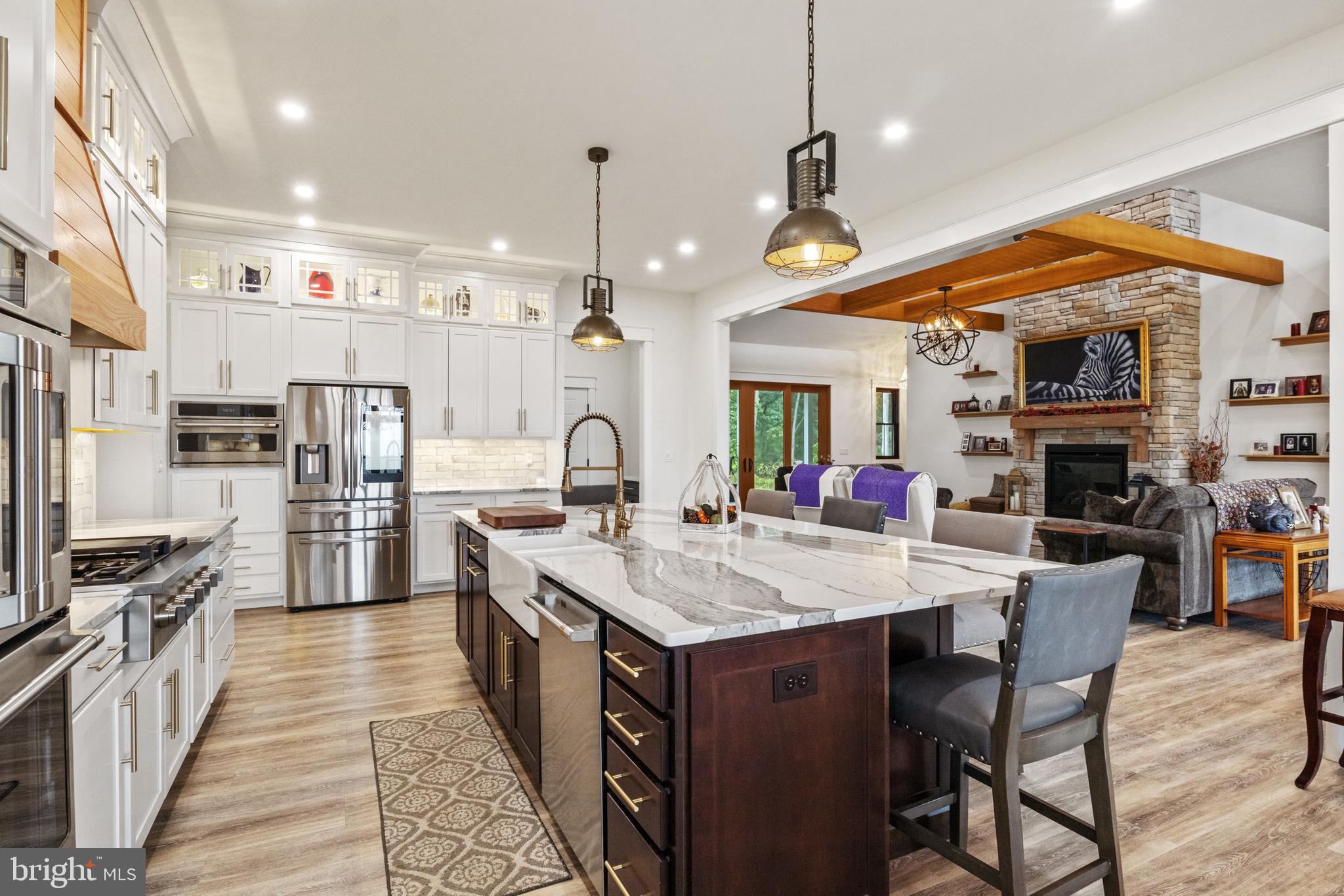 4073 Landis Road Hanover, PA 17331 - Photo 25 of 100 a large kitchen with stainless steel appliances kitchen island granite countertop a table chairs and a refrigerator