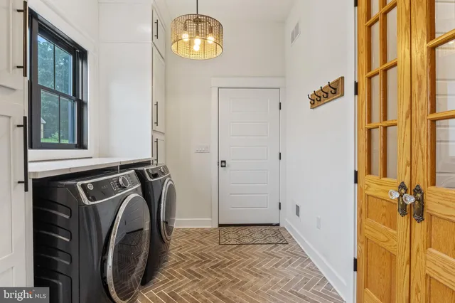 a kitchen with stainless steel appliances granite countertop a lot of cabinets and wooden floor