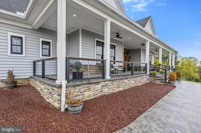 a dining room with stainless steel appliances kitchen island granite countertop a dining table chairs and a refrigerator