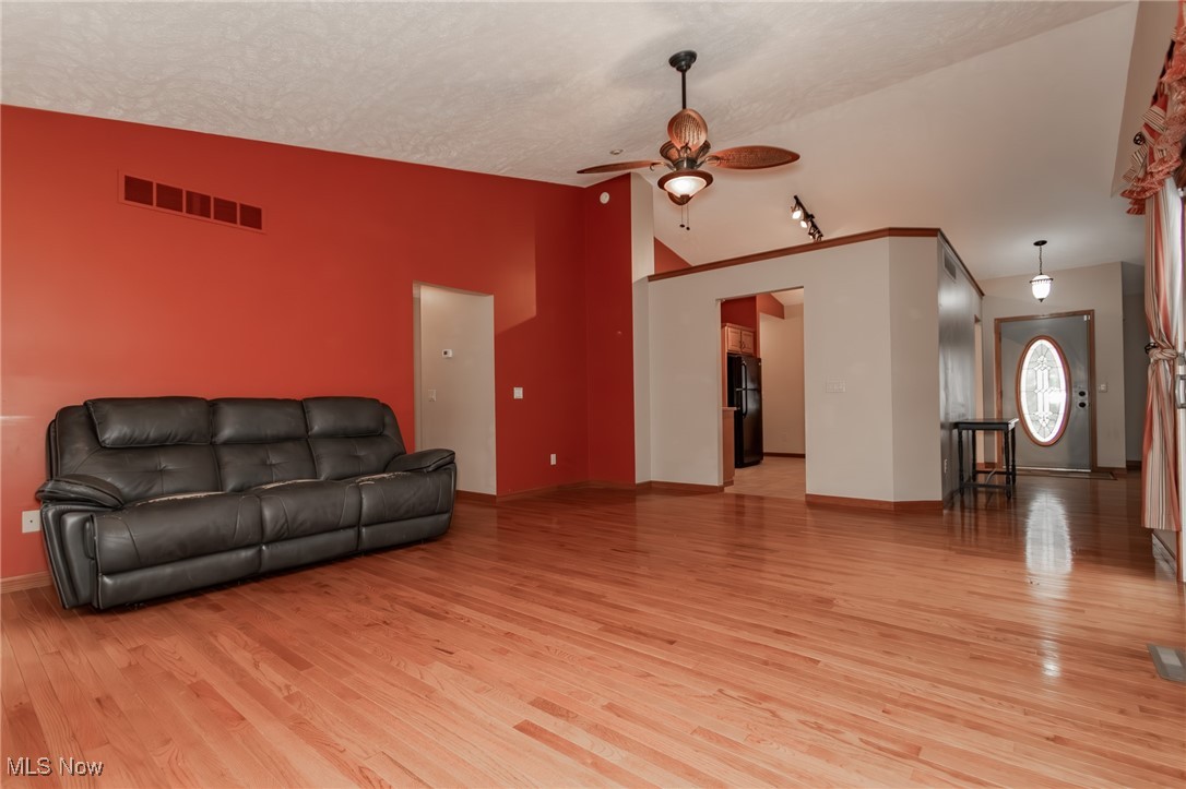 4815 South Ridge Road Perry, OH 44081 - Photo 9 of 48 Living room featuring ceiling fan, light wood-style flooring, and high vaulted ceiling