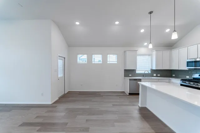 a view of a kitchen with stove and cabinets