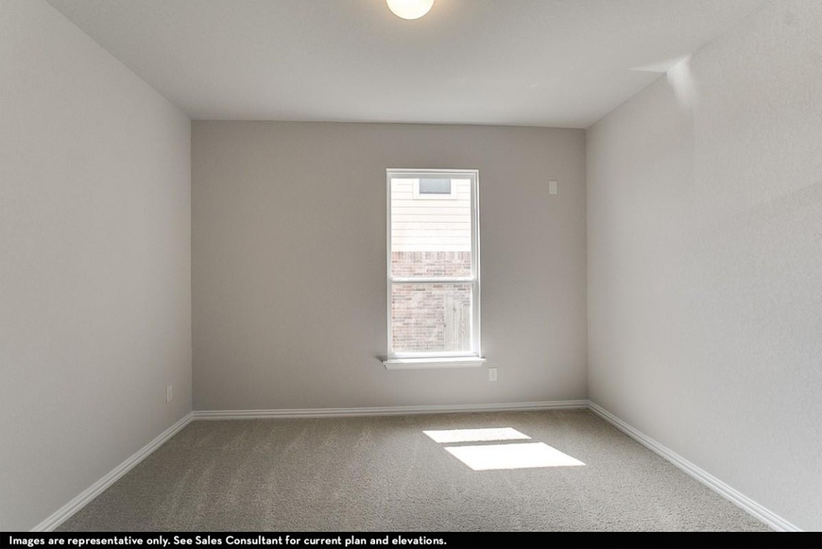 265 Rubber Tree Way Buda, TX 78610 - Photo 8 of 11 an empty room with a window