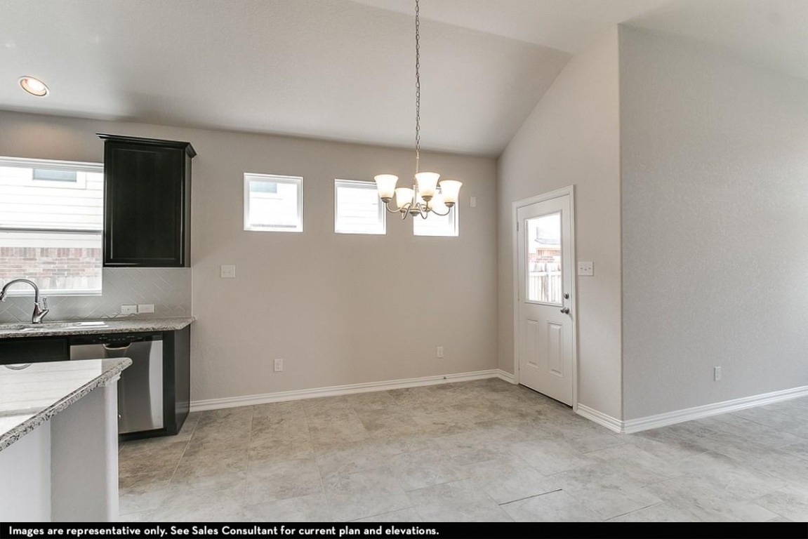 265 Rubber Tree Way Buda, TX 78610 - Photo 9 of 11 a view of a kitchen with a sink and window