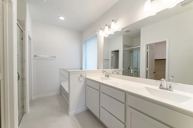 a spacious bathroom with a double vanity sink mirror and