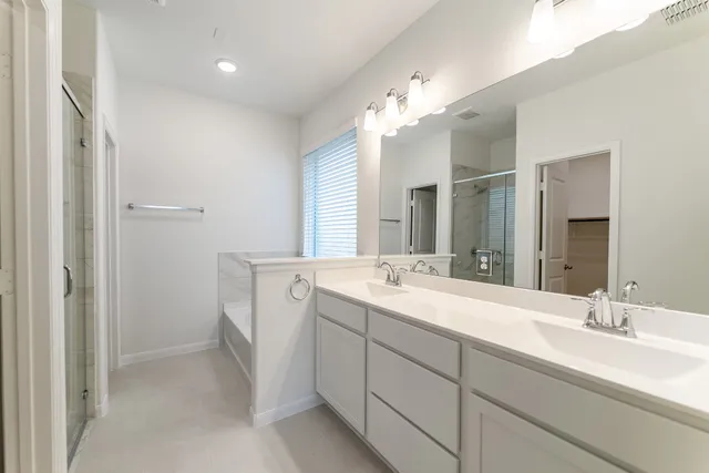 a spacious bathroom with a double vanity sink mirror and