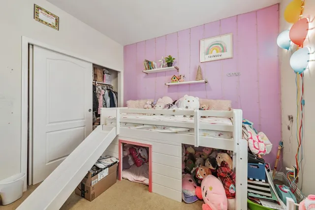 a bedroom with furniture and flat screen tv