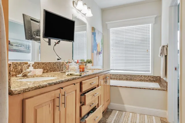a bathroom with a sink a vanity and a mirror