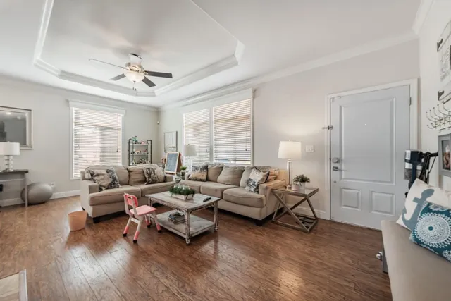 a living room with furniture and wooden floor