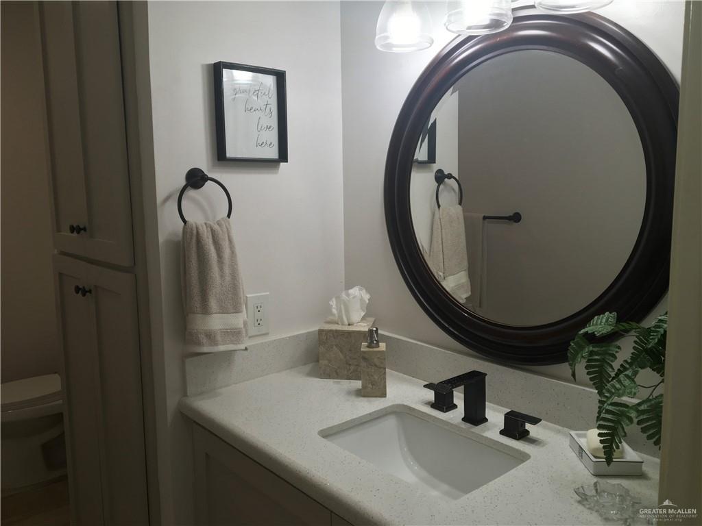 700 Fern Street, Unit 5 McAllen, TX 78504 - Photo 12 of 22 a bathroom with a sink and a mirror