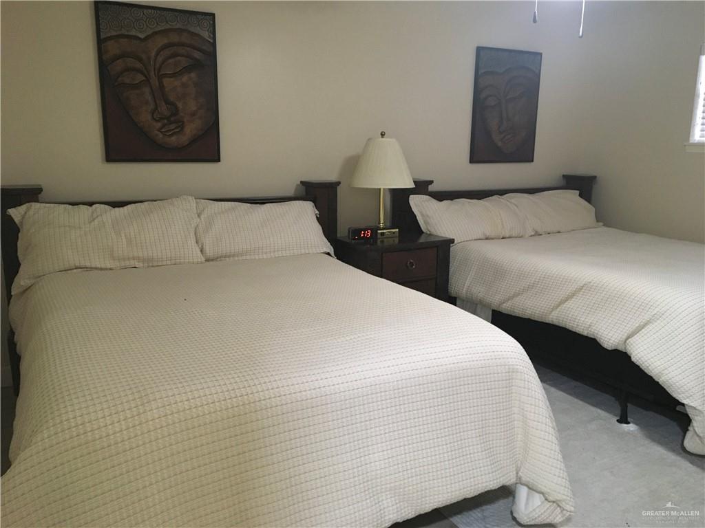 700 Fern Street, Unit 5 McAllen, TX 78504 - Photo 16 of 22 a bedroom with a bed and a painting on the wall