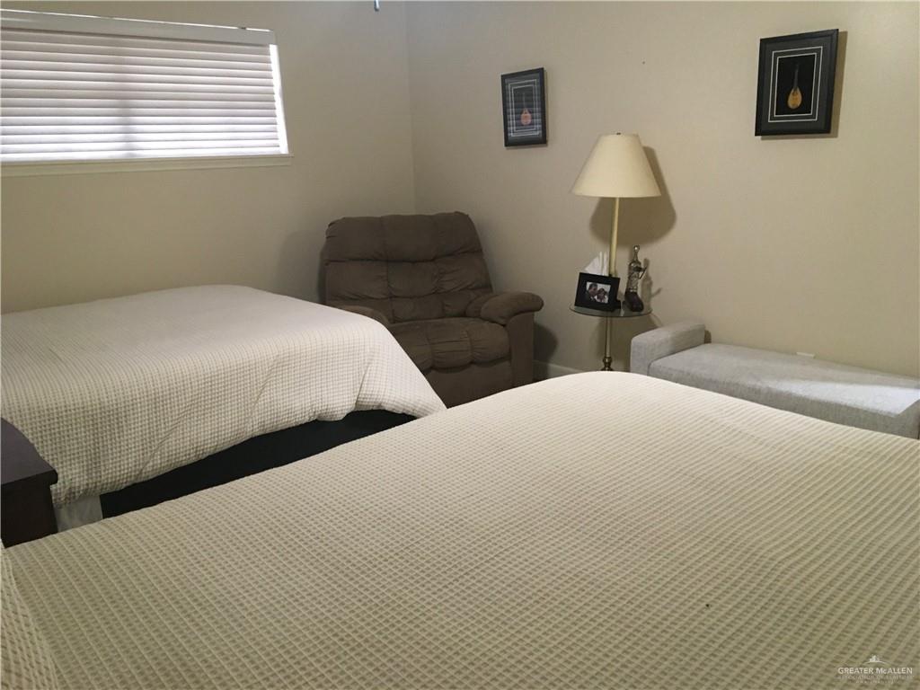 700 Fern Street, Unit 5 McAllen, TX 78504 - Photo 17 of 22 a bedroom with two beds and a window