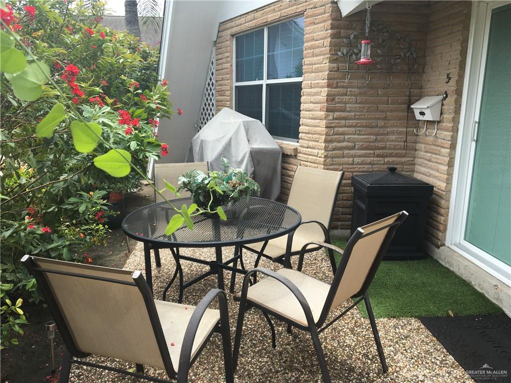 700 Fern Street, Unit 5 McAllen, TX 78504 - Photo 19 of 22 a view of a chairs and table in the patio