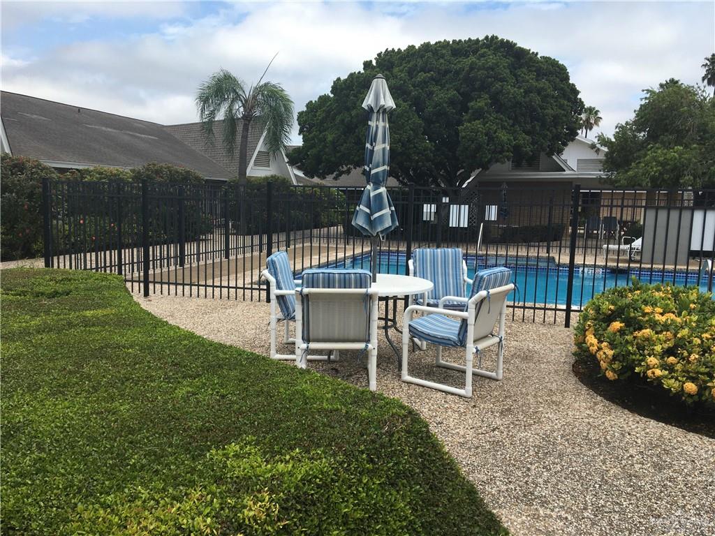 700 Fern Street, Unit 5 McAllen, TX 78504 - Photo 20 of 22 a view of a chairs and table in the back yard