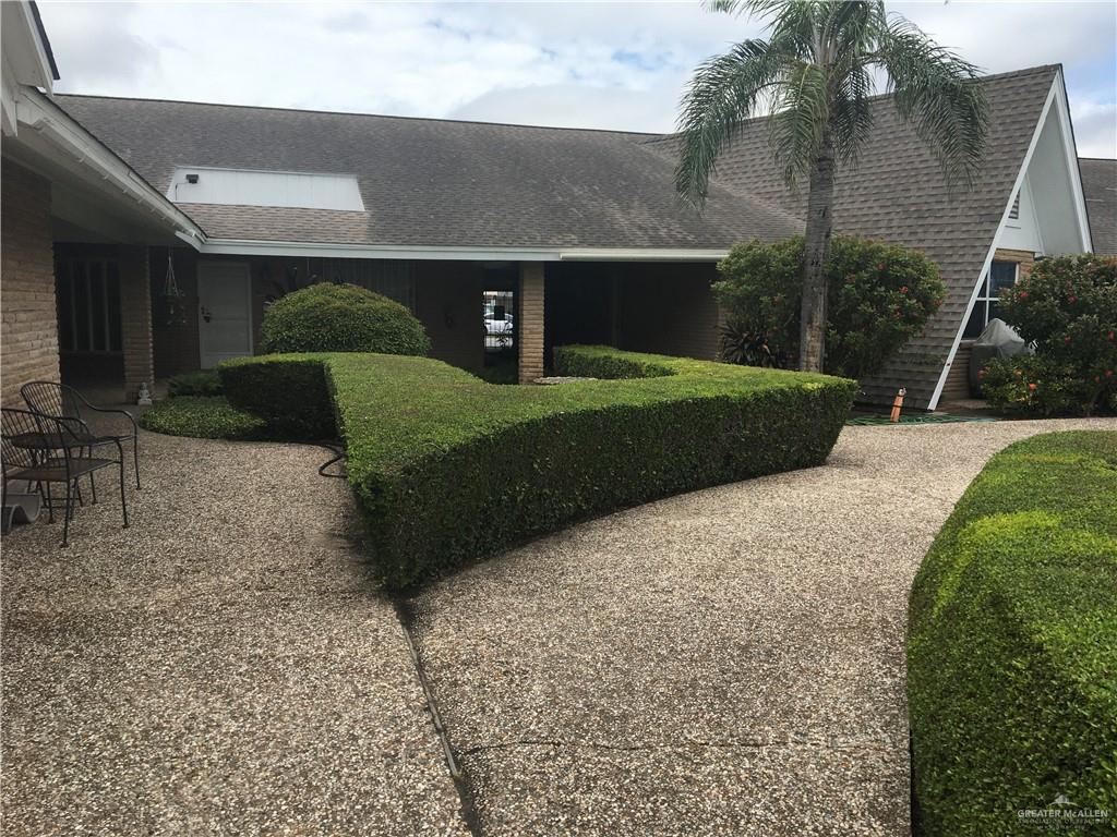 700 Fern Street, Unit 5 McAllen, TX 78504 - Photo 21 of 22 a front view of a house with a yard and garage