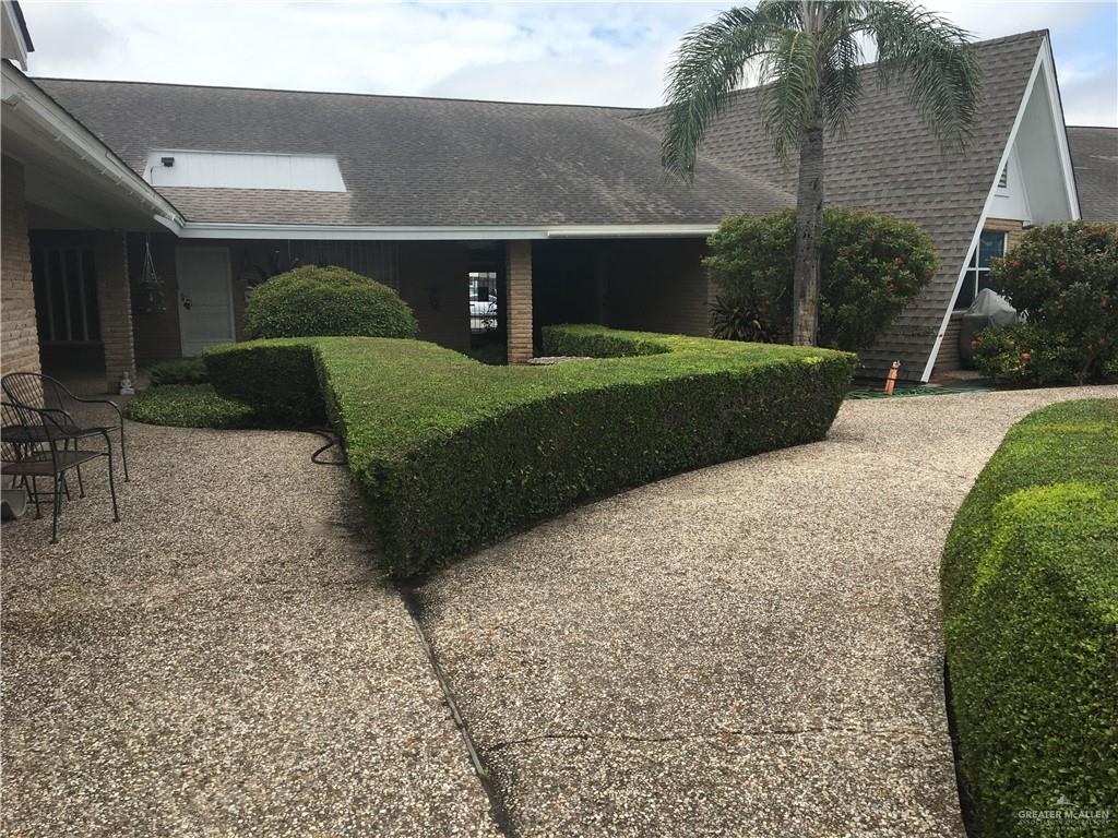 700 Fern Street, Unit 5 McAllen, TX 78504 - Photo 22 of 22 a front view of a house with a yard and garage