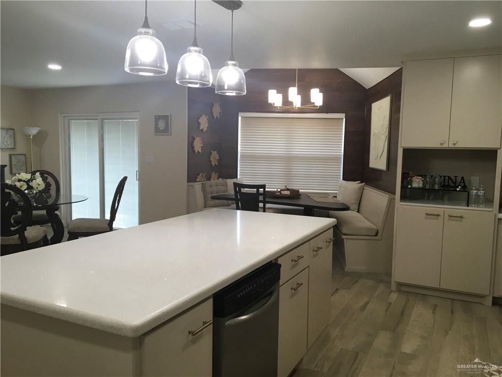 700 Fern Street, Unit 5 McAllen, TX 78504 - Photo 4 of 22 a kitchen with a sink cabinets and wooden floor