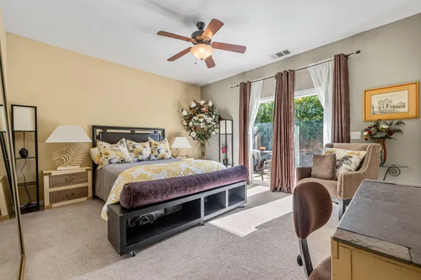 a bedroom with a large bed and a chandelier