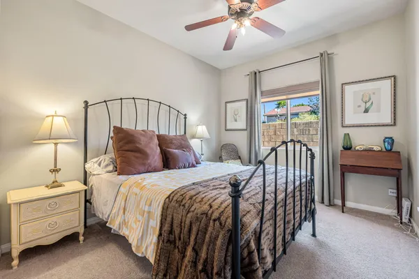 a bed sitting in a bedroom next to a window