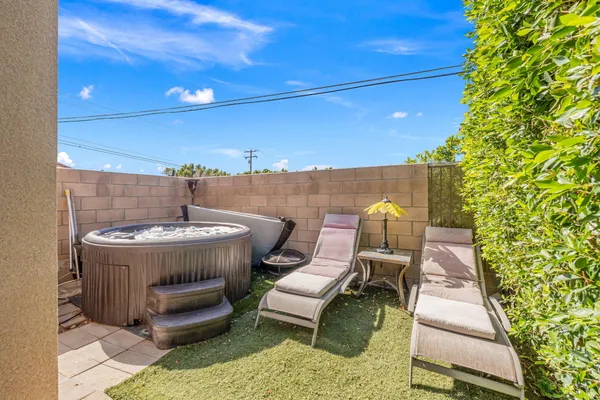a swimming pool with outdoor seating and yard