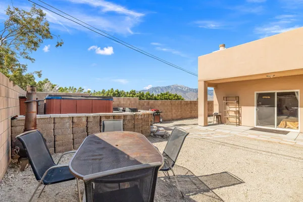 a view of a backyard with furniture and a garden