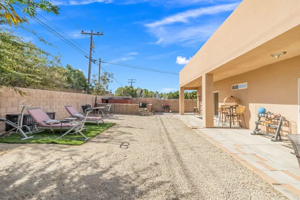 a backyard of a house with table and chairs