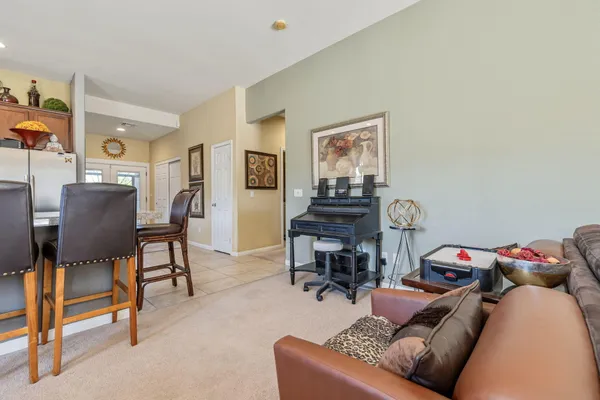 a living room with furniture and a chandelier