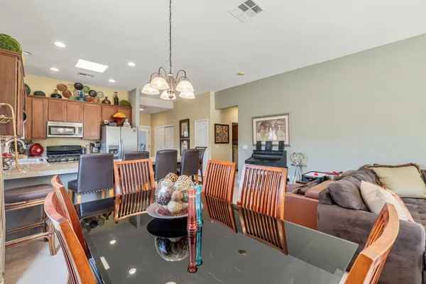 a living room with furniture chandelier and a large window