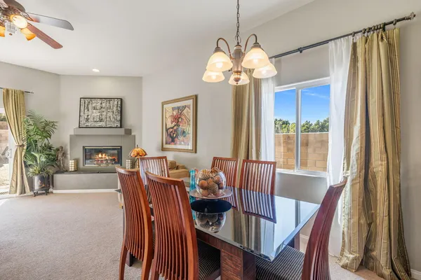 a dining area with stainless steel appliances a sink and a refrigerator