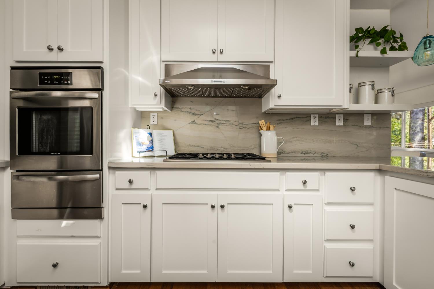 10875 Spenceville Road Penn Valley, CA 95946 - Photo 12 of 49 a kitchen with granite countertop white cabinets and stainless steel appliances