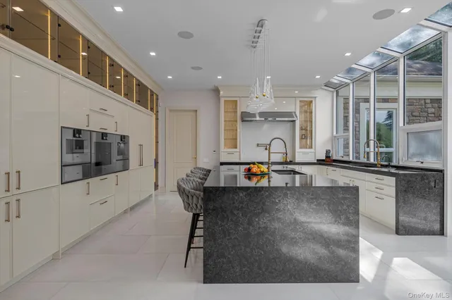 a kitchen with stainless steel appliances kitchen island granite countertop a sink and cabinets