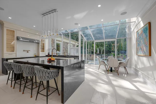 a outdoor space with lots of white furniture and windows