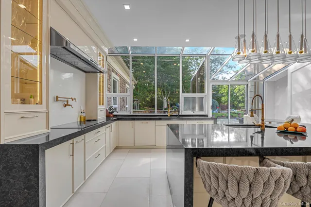 a kitchen with stainless steel appliances granite countertop a sink and window