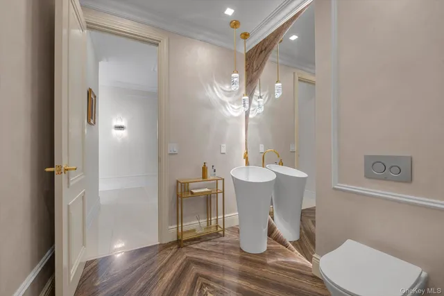 a view of a dining room with furniture a chandelier and wooden floor