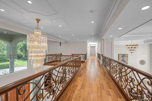 a spacious bedroom with a large bed and wooden floor