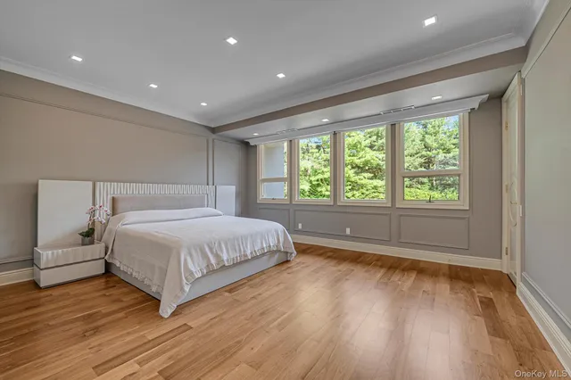 a spacious bedroom with a large bed and a large window