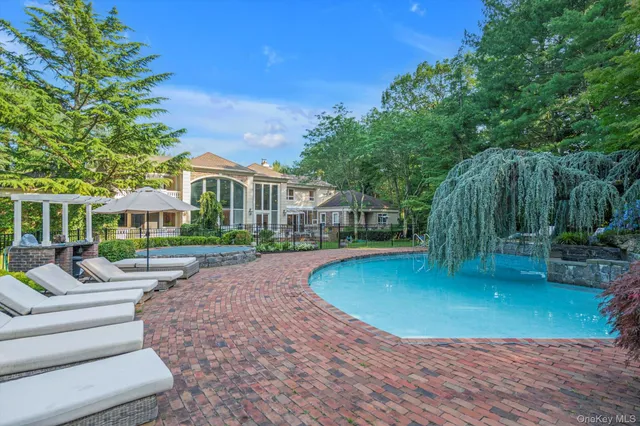 a front view of a house with yard patio and green space