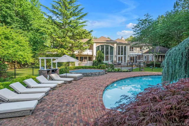 a aerial view of a house with swimming pool and garden