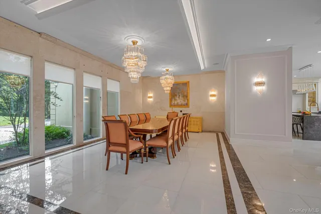 a dining room with furniture a chandelier and wooden floor