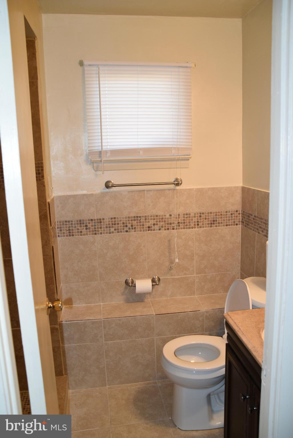 4012 Winlee Road Randallstown, MD 21133 - Photo 4 of 22 a bathroom with a granite countertop toilet and a sink